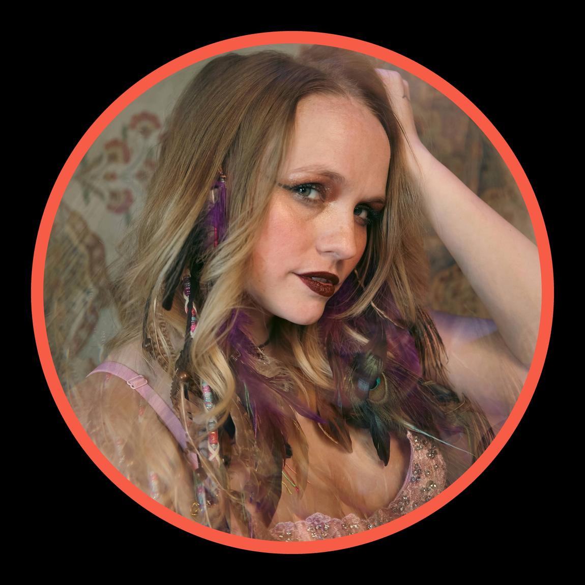 Circular portrait of Ariel Jade with a coral ring