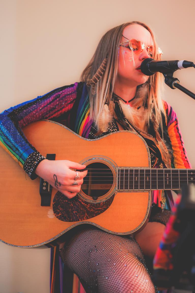 Ariel Jade in heart sunglasses playing acoustic