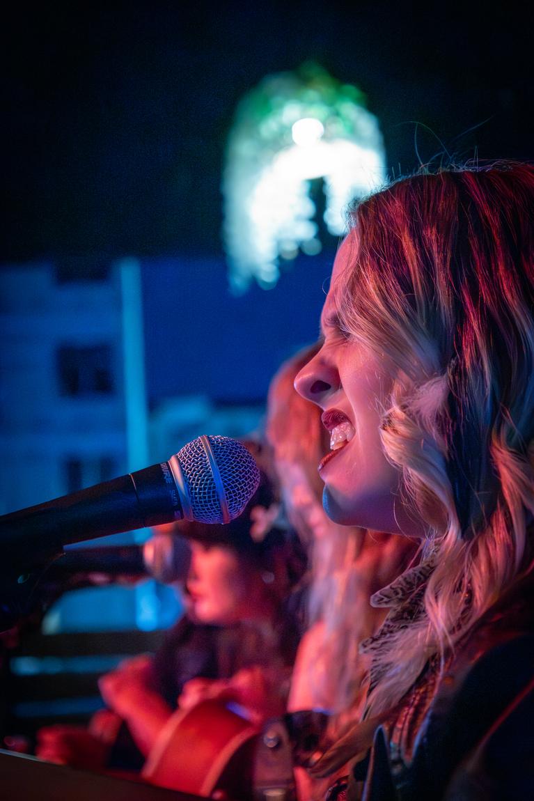 Ariel Jade singing into a microphone