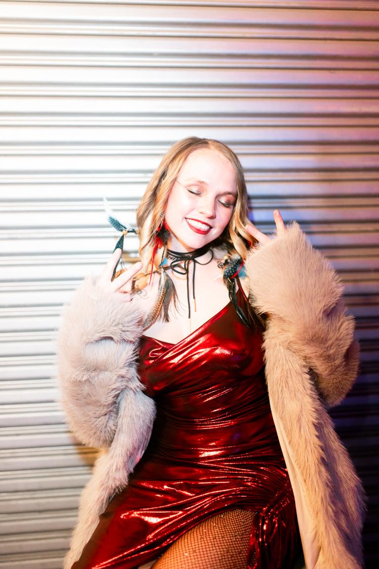 Ariel Jade in a red dress and faux fur coat